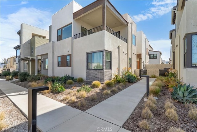 exterior space featuring central AC, a residential view, and stucco siding