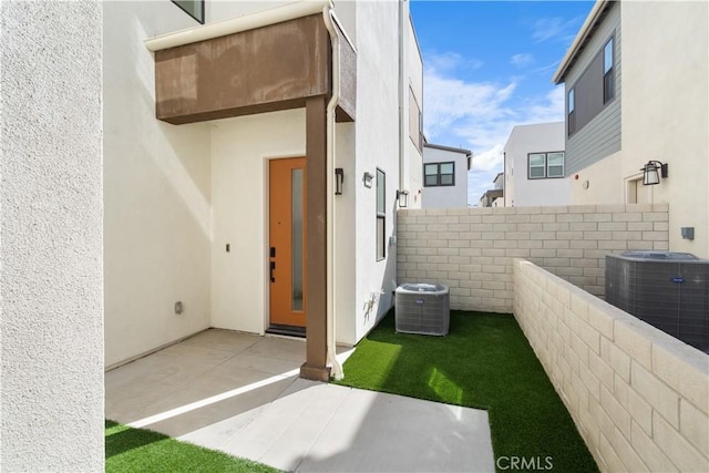 exterior space with a patio, central AC unit, and a fenced backyard