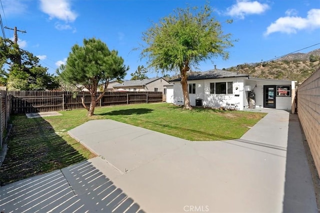 view of yard with a fenced backyard and a patio