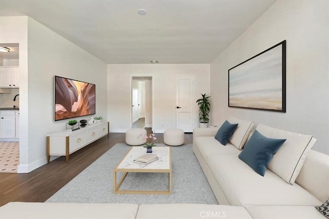 living room with dark wood-style floors and baseboards