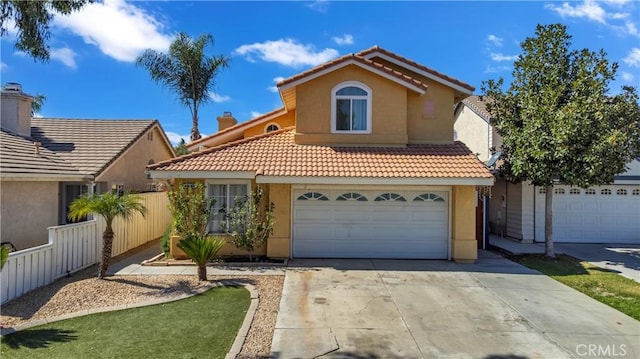 view of front facade with a garage, driveway, a tiled roof, fence, and stucco siding