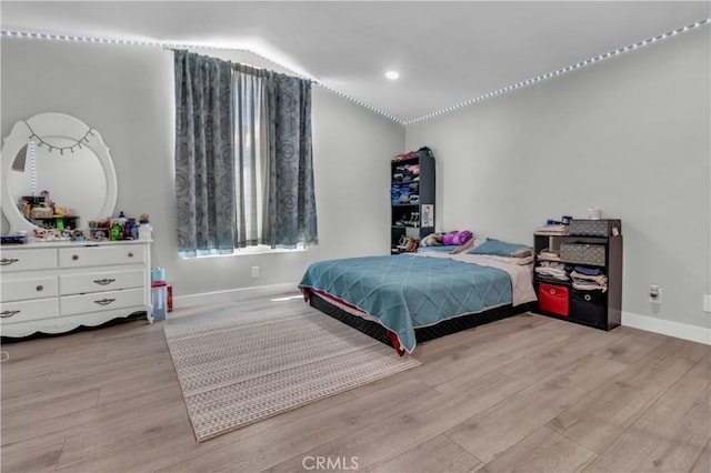 bedroom with recessed lighting, light wood-style flooring, and baseboards