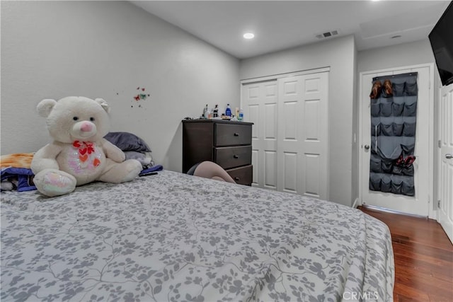 bedroom with dark wood-type flooring and visible vents