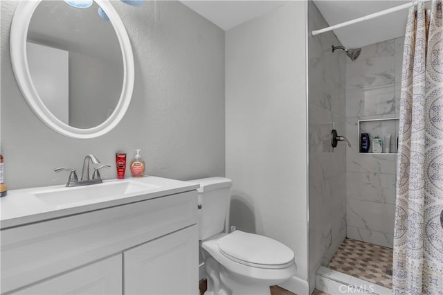 full bath featuring vanity, a shower stall, and toilet