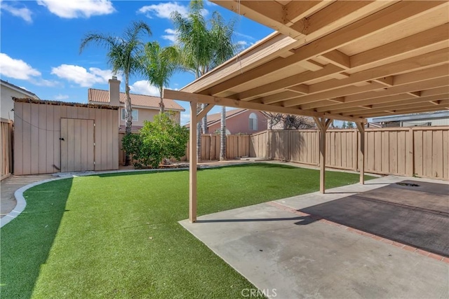 view of yard with a patio area, an outdoor structure, a fenced backyard, and a storage shed