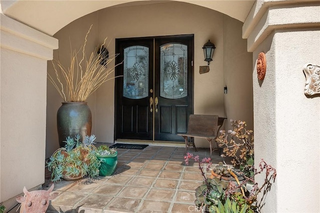 view of exterior entry featuring stucco siding