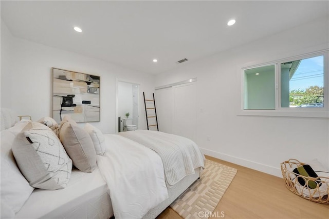 bedroom featuring visible vents, wood finished floors, baseboards, a closet, and recessed lighting