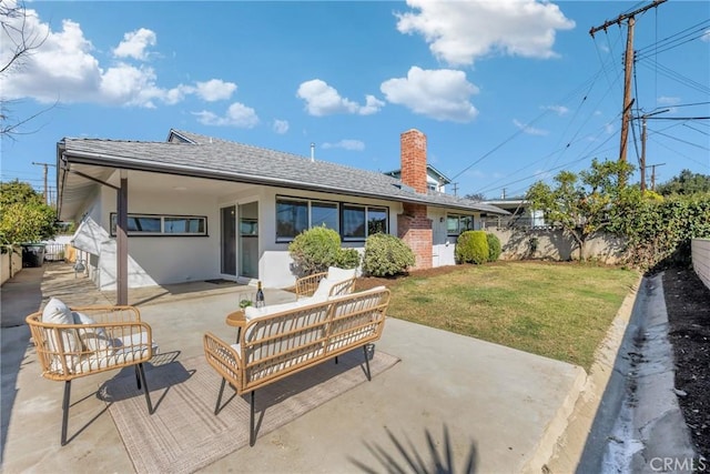 back of house with a fenced backyard, an outdoor hangout area, a yard, a patio area, and stucco siding