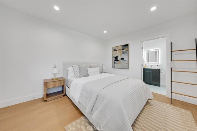 bedroom with recessed lighting, baseboards, and light wood-type flooring