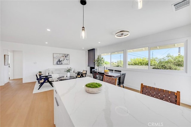 dining room featuring recessed lighting, visible vents, light wood-style flooring, and baseboards