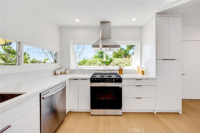 kitchen featuring dishwasher, wall chimney range hood, gas stove, and modern cabinets