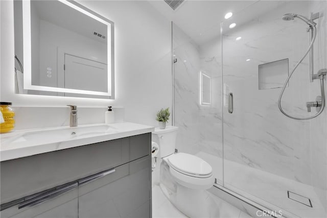 bathroom featuring toilet, vanity, visible vents, marble finish floor, and a marble finish shower