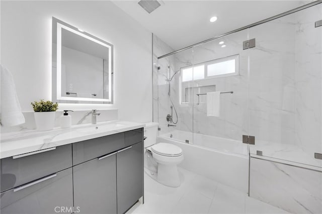 full bathroom featuring toilet, visible vents, shower / bath combination with glass door, and vanity