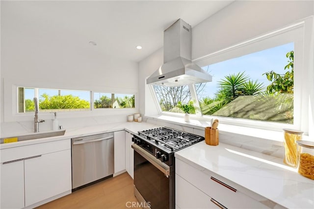 kitchen featuring extractor fan, a sink, white cabinetry, stainless steel dishwasher, and gas stove