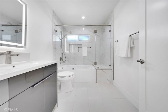 full bath featuring vanity, combined bath / shower with glass door, and toilet
