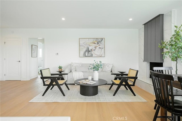 living room featuring light wood finished floors and recessed lighting