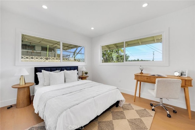 bedroom with recessed lighting, baseboards, and wood finished floors