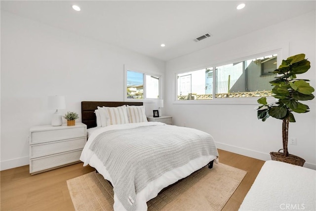 bedroom with recessed lighting, visible vents, light wood-style flooring, and baseboards