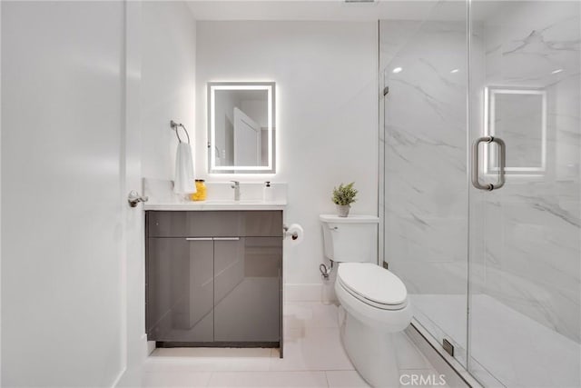 full bathroom featuring vanity, a marble finish shower, toilet, and baseboards