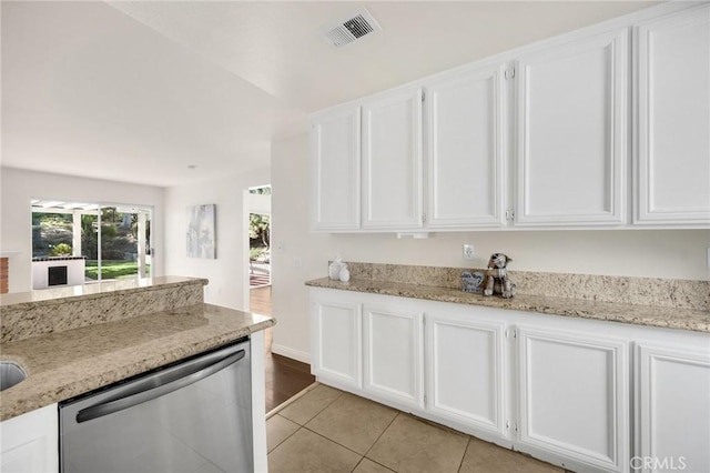 kitchen with light tile patterned floors, visible vents, white cabinets, light stone countertops, and dishwasher