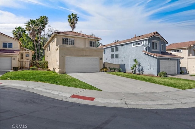 view of front facade with an attached garage, a tiled roof, driveway, stucco siding, and a front yard