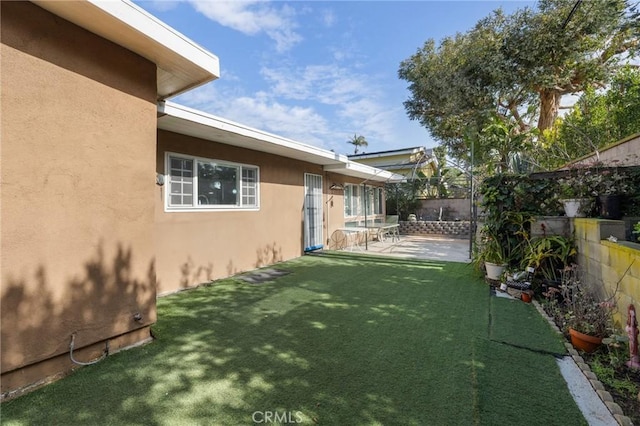 view of yard with a patio area and a fenced backyard