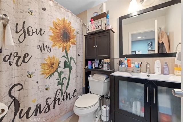 full bath featuring toilet, curtained shower, backsplash, and vanity