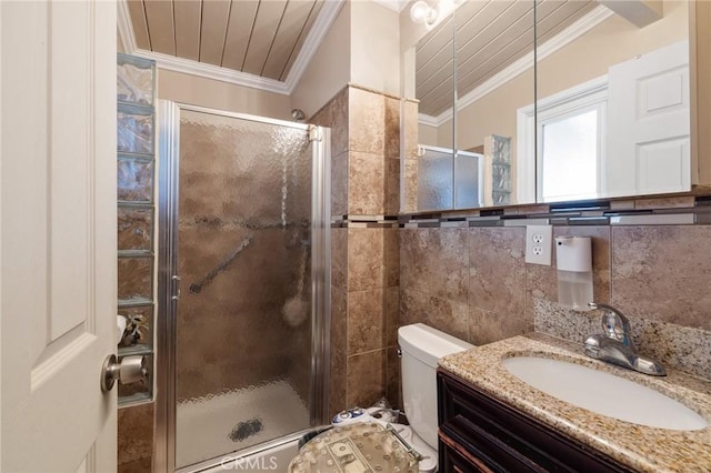 full bath featuring vanity, a shower stall, tile walls, and crown molding