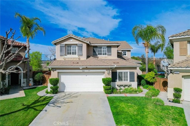 traditional-style house with concrete driveway, a tiled roof, fence, a front lawn, and stucco siding