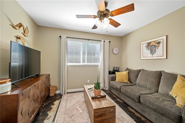 living area featuring ceiling fan and baseboards