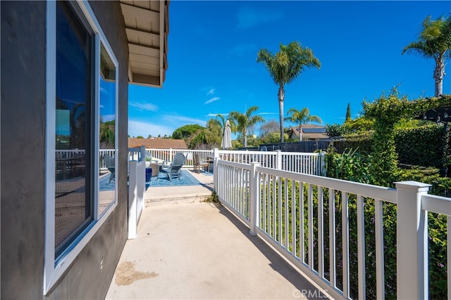 balcony featuring outdoor dining area and a patio area