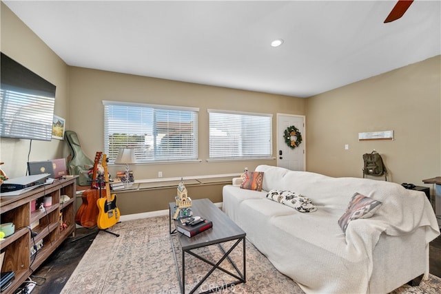 living area featuring baseboards and recessed lighting