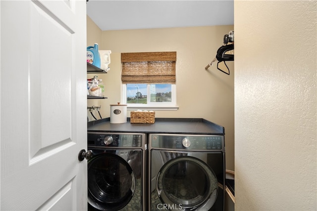 washroom featuring laundry area and washing machine and clothes dryer