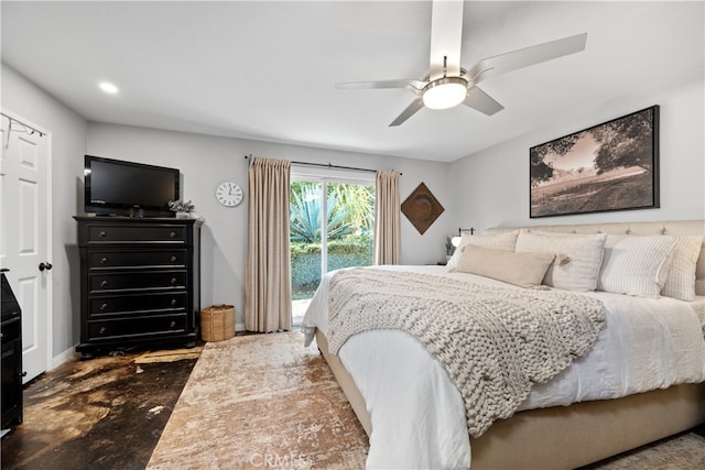 bedroom featuring access to exterior, concrete flooring, and a ceiling fan