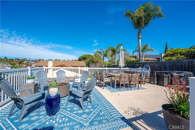 view of patio with outdoor dining area and fence