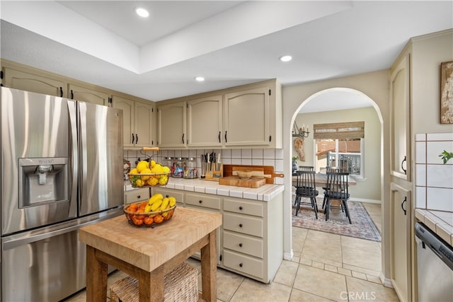 250 Stagecoach Rd, Arroyo Grande, CA 93420 - kitchen featuring appliances with stainless steel finishes, backsplash, tile countertops, light tile patterned flooring, and baseboards