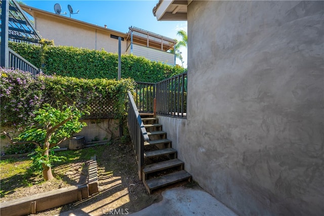 exterior space with stairs and stucco siding