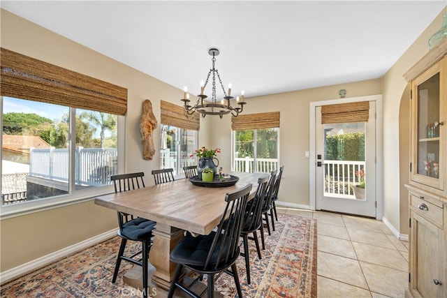 dining room featuring light tile patterned floors, a chandelier, and baseboards