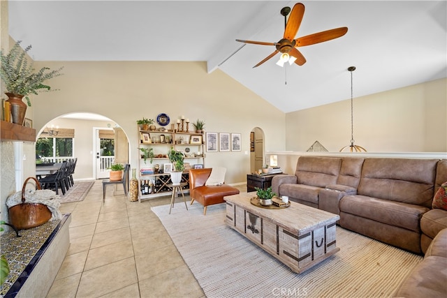 living area featuring arched walkways, a ceiling fan, beamed ceiling, high vaulted ceiling, and light tile patterned flooring