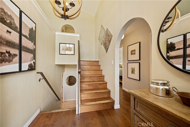 250 Stagecoach Rd, Arroyo Grande, CA 93420 - stairs with wood finished floors, a chandelier, baseboards, arched walkways, and vaulted ceiling