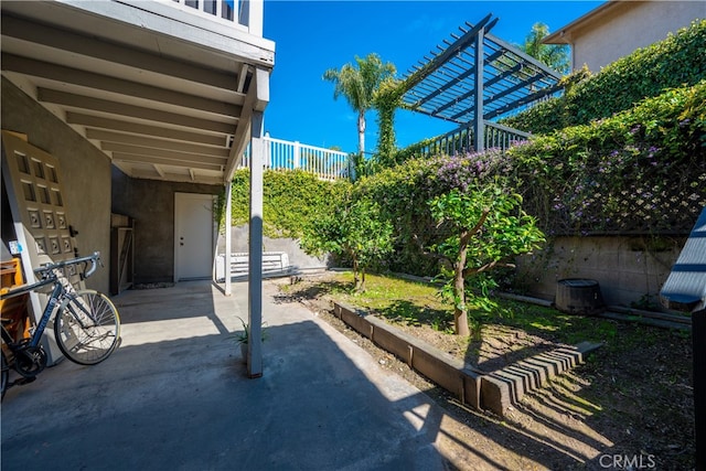 view of patio / terrace with fence private yard, a garden, and a pergola