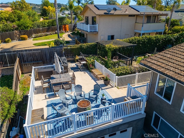 back of property featuring an outdoor fire pit, outdoor dining area, fence, stucco siding, and a patio area