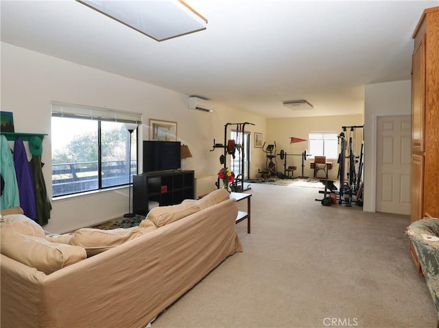 living area with an AC wall unit, a wealth of natural light, and light colored carpet