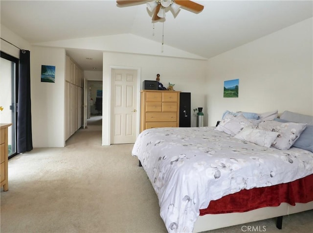 bedroom with a ceiling fan, lofted ceiling, and light colored carpet