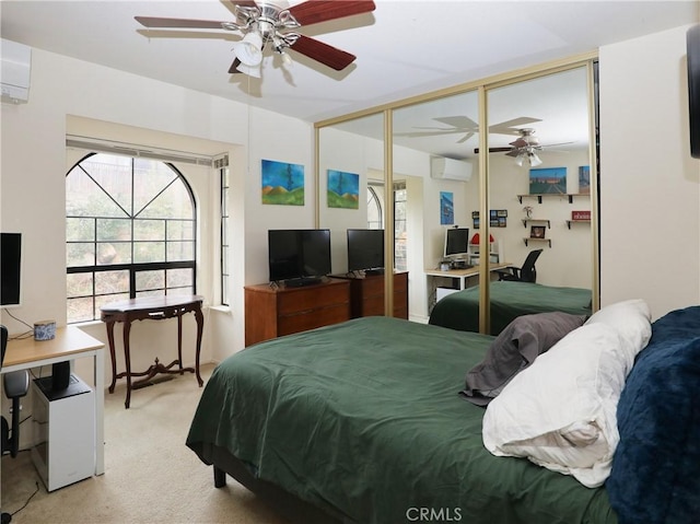 bedroom with an AC wall unit, a closet, a ceiling fan, and light colored carpet