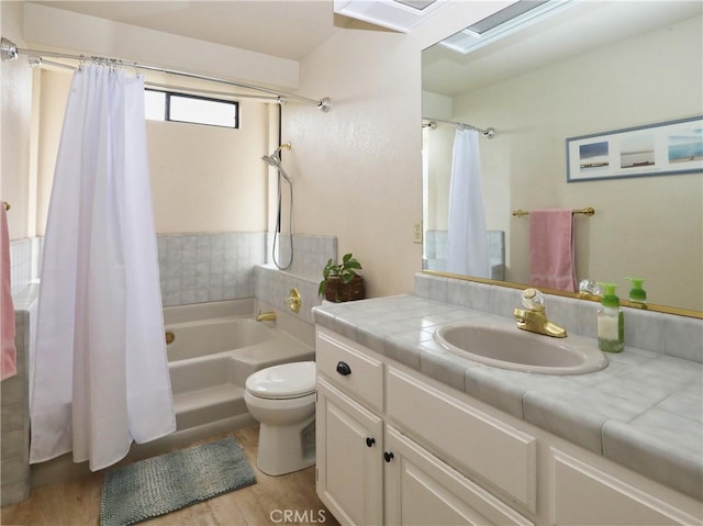 full bathroom featuring shower / tub combo with curtain, vanity, toilet, and wood finished floors