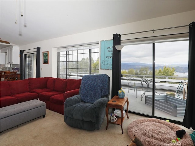 living area featuring light carpet and a mountain view