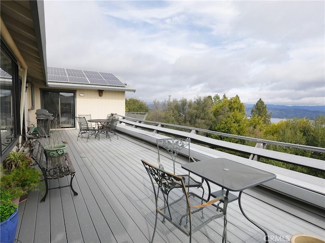 deck featuring a grill and outdoor dining space