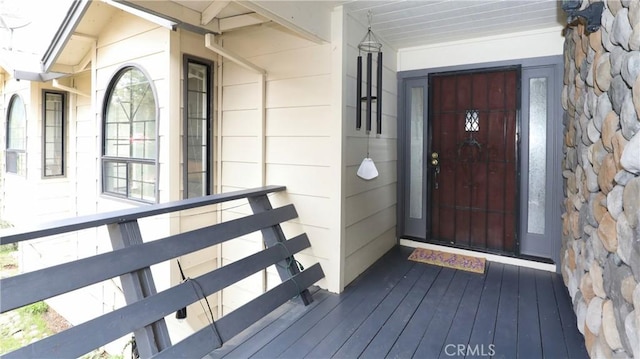 entrance to property featuring stone siding