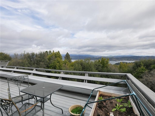 balcony featuring a forest view and a mountain view